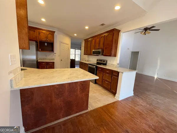 a view of wooden floor and windows in a room