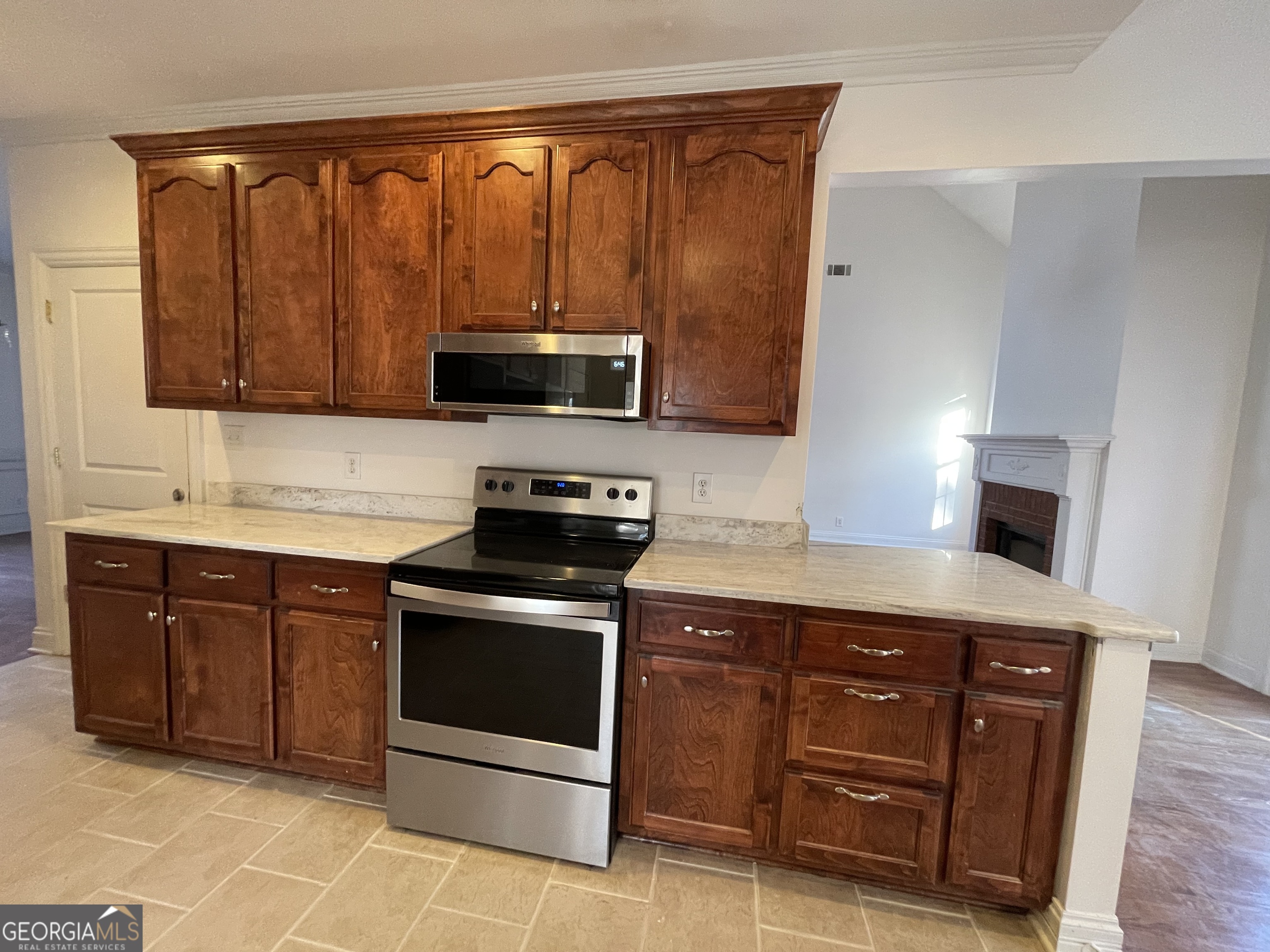 155 Rocky Way Williamson, GA 30292 - Photo 25 of 56 a kitchen with stainless steel appliances granite countertop a stove a sink and a microwave