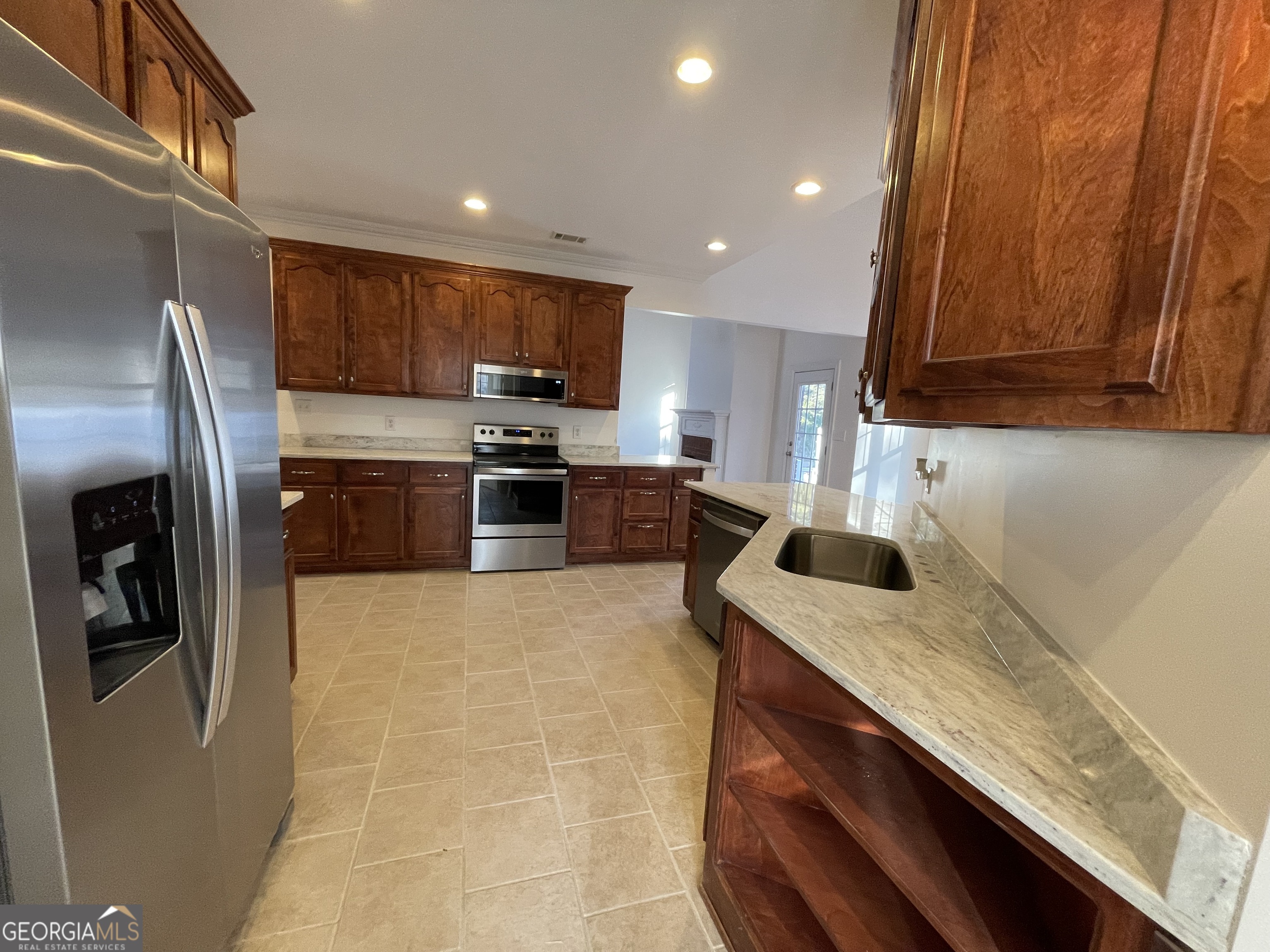 155 Rocky Way Williamson, GA 30292 - Photo 26 of 56 a kitchen with stainless steel appliances granite countertop a sink a stove a refrigerator a washer dryer and white cabinets