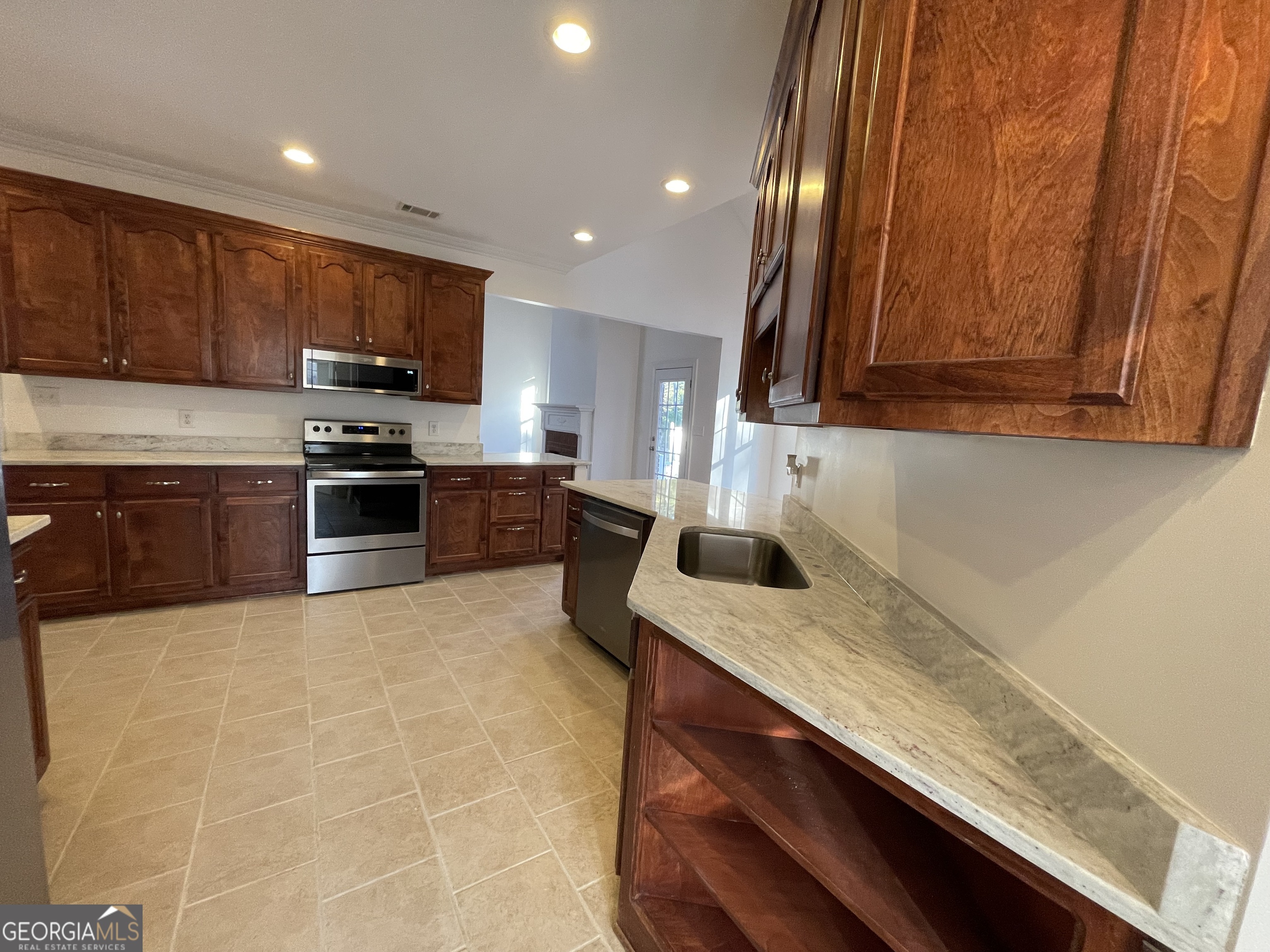 155 Rocky Way Williamson, GA 30292 - Photo 29 of 56 a kitchen with stainless steel appliances granite countertop a sink stove and refrigerator