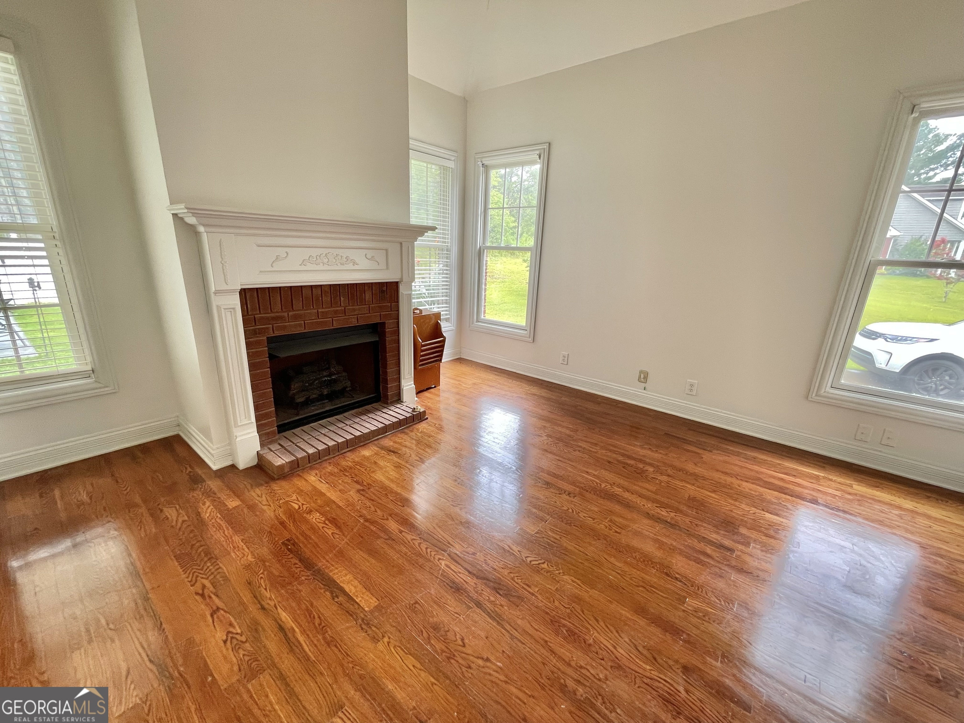 155 Rocky Way Williamson, GA 30292 - Photo 44 of 56 wooden floor fireplace and natural light in room