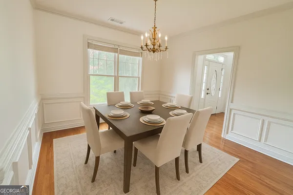 a view of a backyard with chairs and potted plants