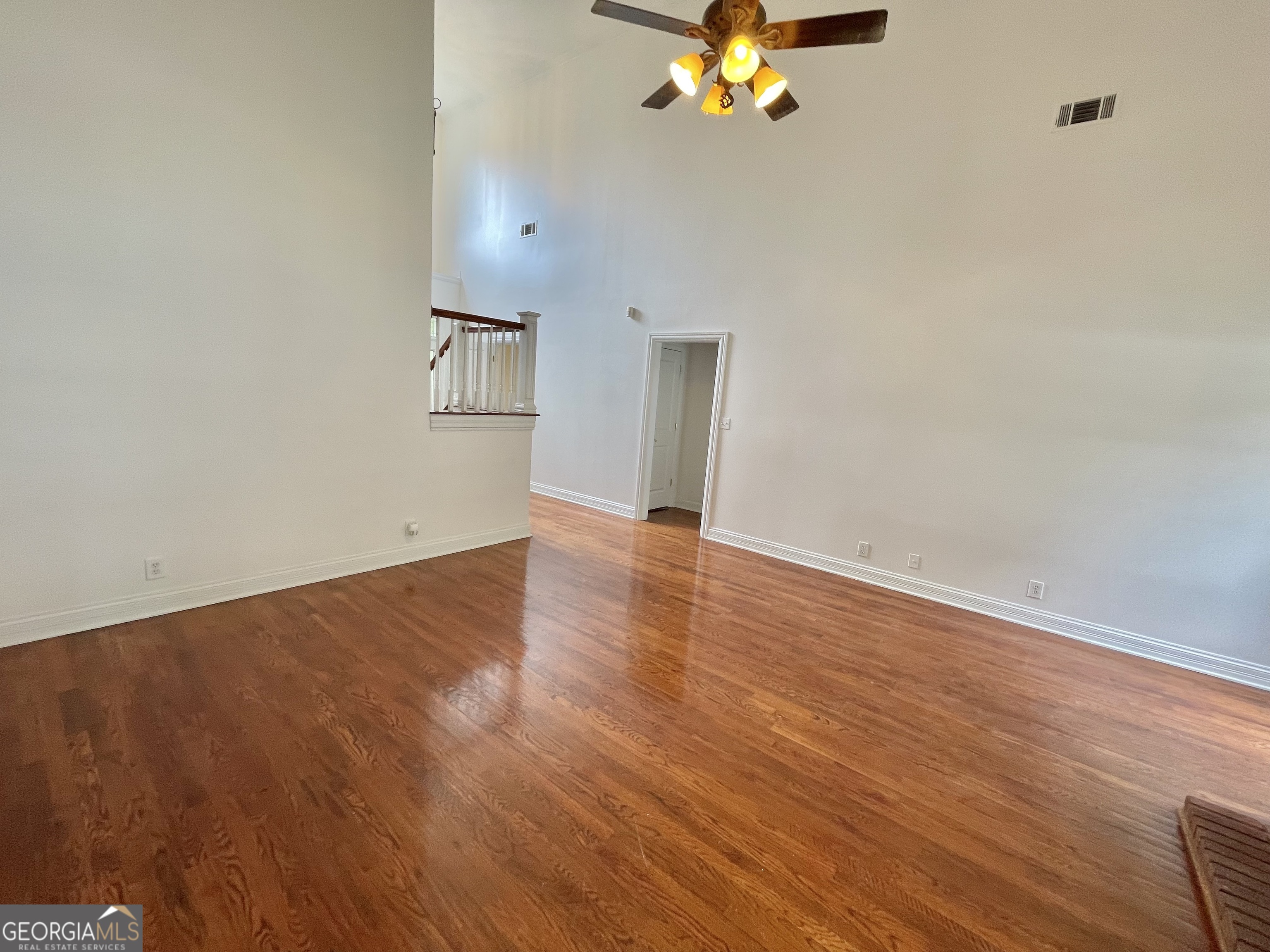 155 Rocky Way Williamson, GA 30292 - Photo 49 of 56 a view of an empty room with wooden floor