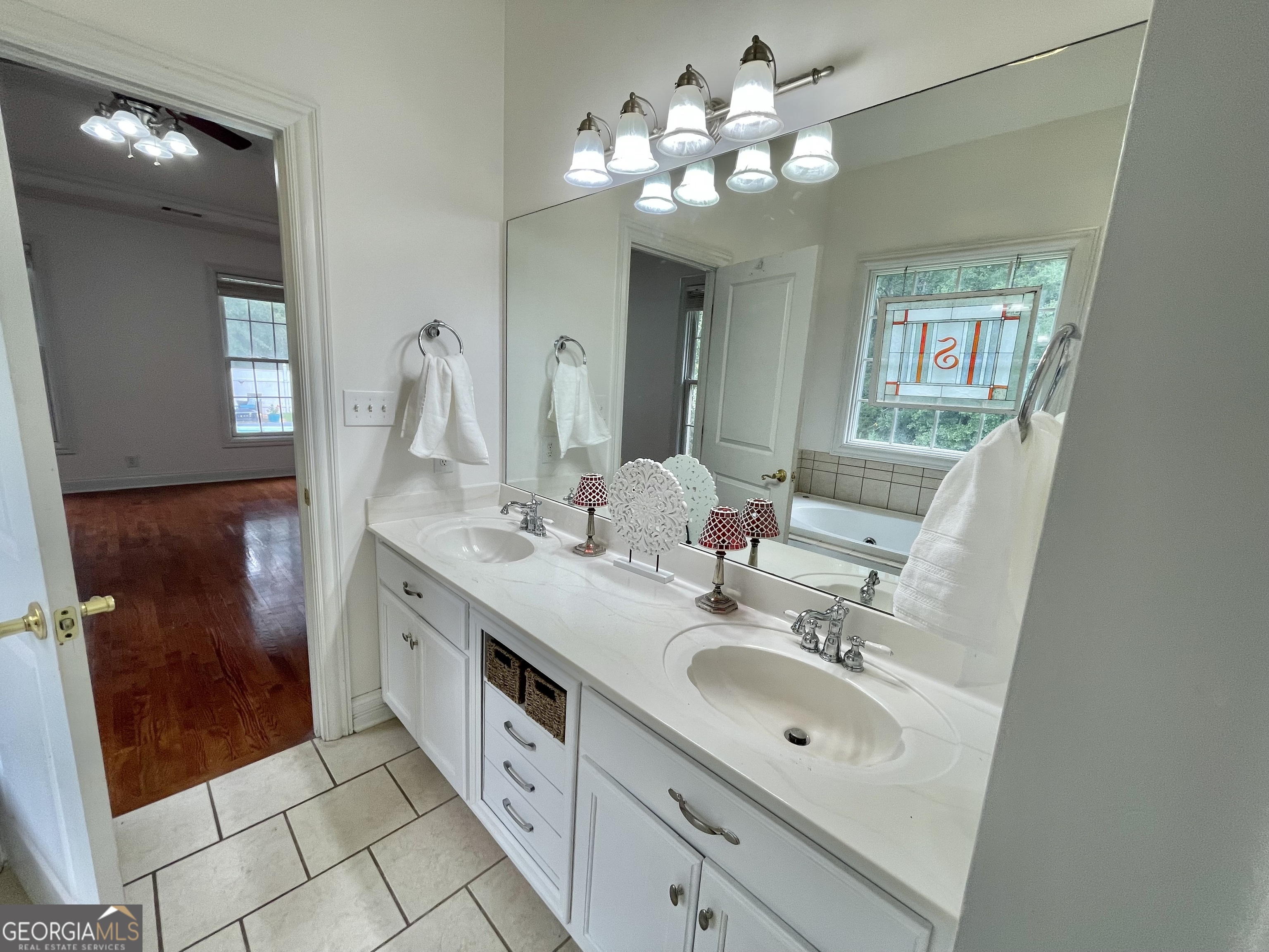 155 Rocky Way Williamson, GA 30292 - Photo 53 of 56 a spacious bathroom with double vanity a sink a mirror and a shower