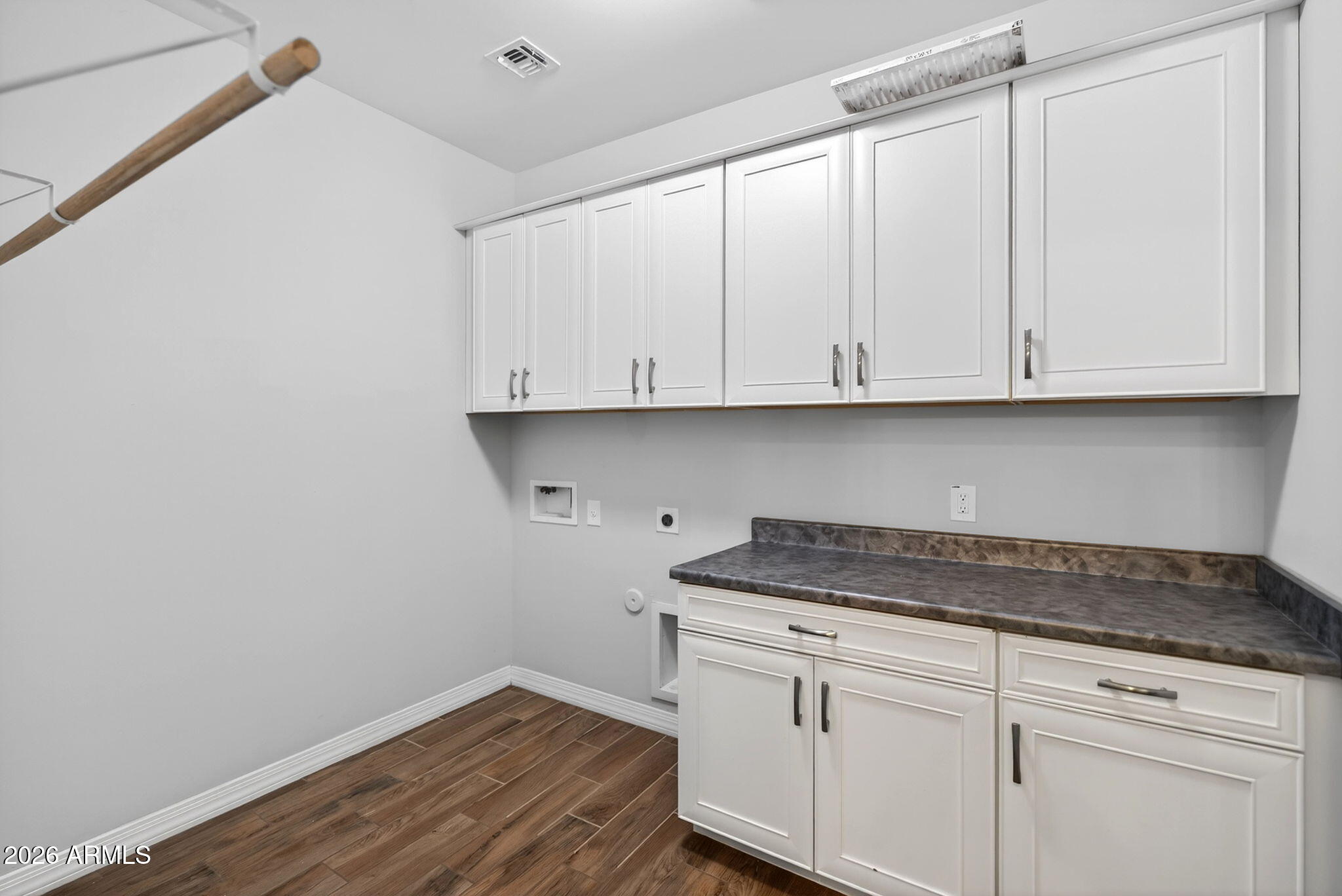 12124 West Peak View Road Peoria, AZ 85383 - Photo 30 of 38 a kitchen with granite countertop white cabinets and a white wooden floor