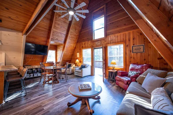 a living room with furniture a fireplace and wooden floor
