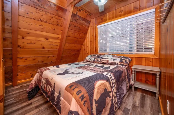 a bedroom with a bed and a window