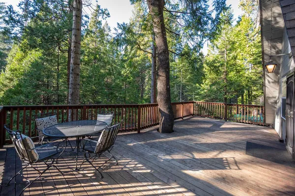 a view of a chairs and table on the deck