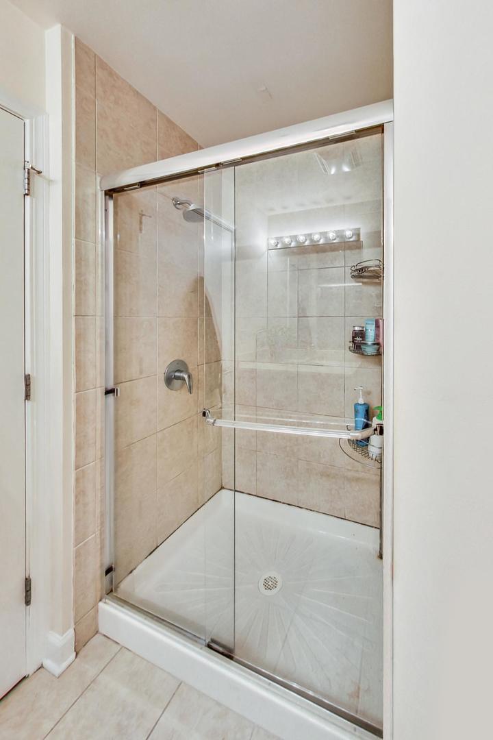 451 West Huron Street, Unit 1201 Chicago, IL 60654 - Photo 12 of 18 a bathroom with a glass shower door