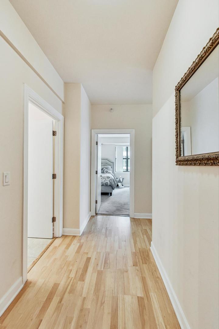 451 West Huron Street, Unit 1201 Chicago, IL 60654 - Photo 13 of 18 a view of a hallway with wooden floor and a bathroom