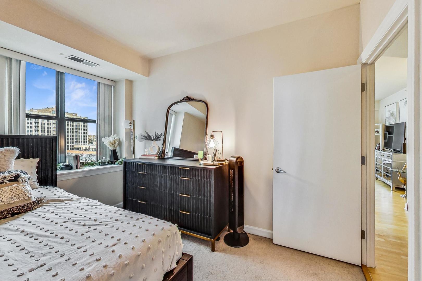 451 West Huron Street, Unit 1201 Chicago, IL 60654 - Photo 15 of 18 a bedroom with a bed and a dresser