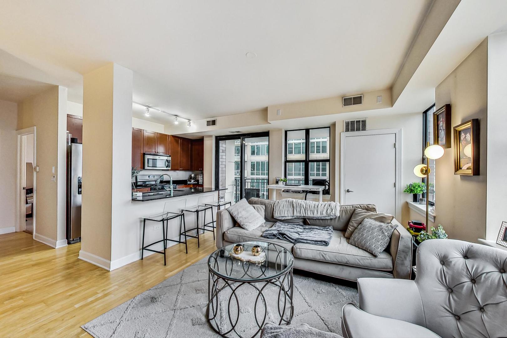 451 West Huron Street, Unit 1201 Chicago, IL 60654 - Photo 5 of 18 a living room with furniture and a flat screen tv