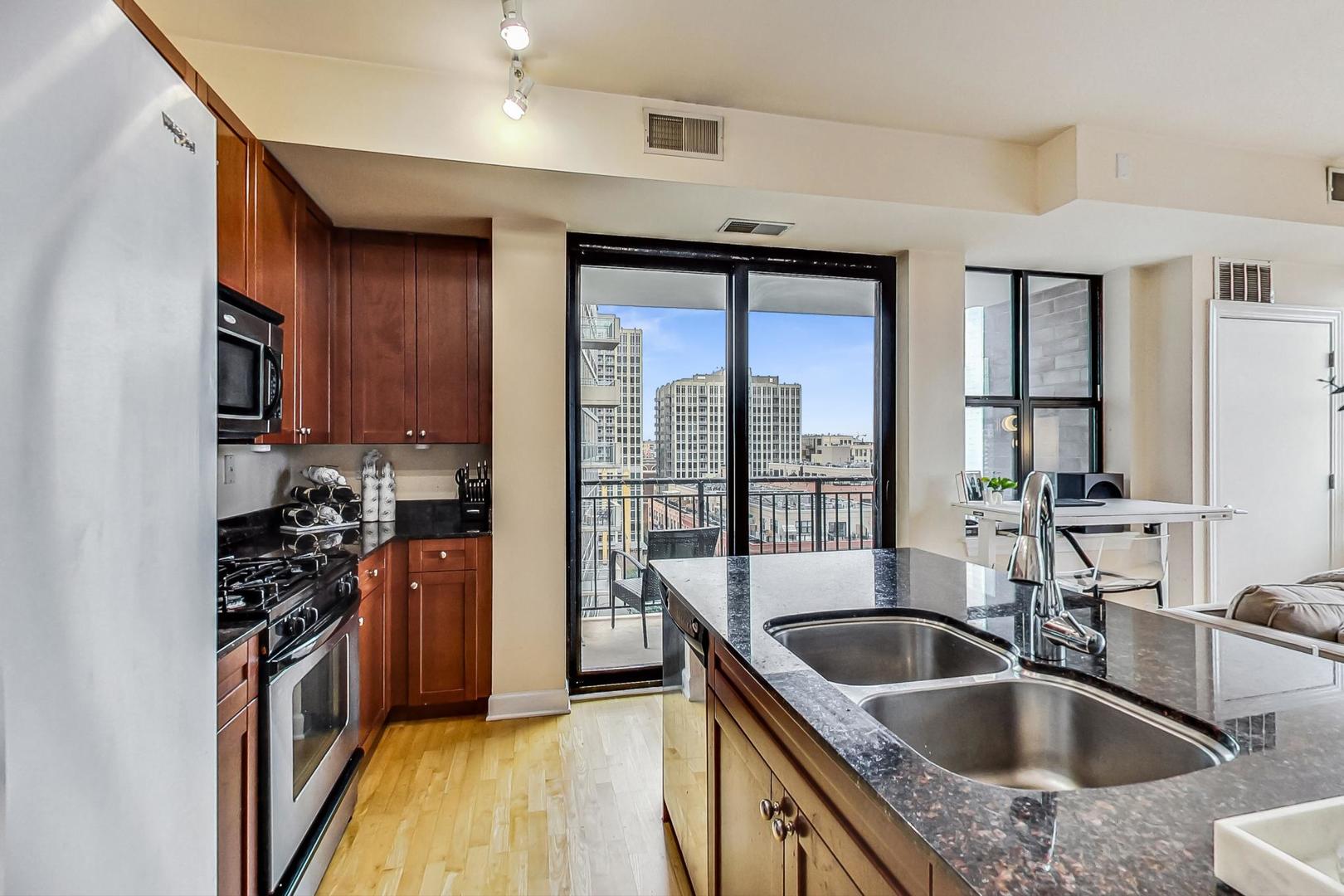 451 West Huron Street, Unit 1201 Chicago, IL 60654 - Photo 6 of 18 a kitchen with a sink stove top oven and refrigerator
