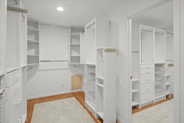 a view of walk in closet with empty racks