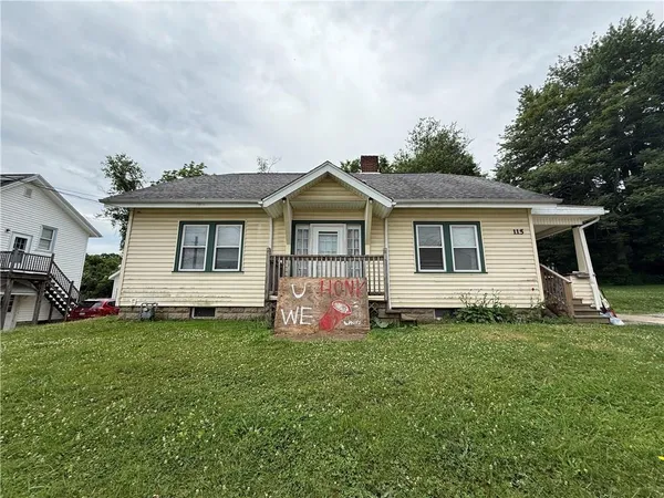 a front view of a house with a yard