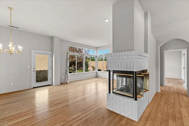 a view of kitchen with stainless steel appliances granite countertop cabinets and wooden floor