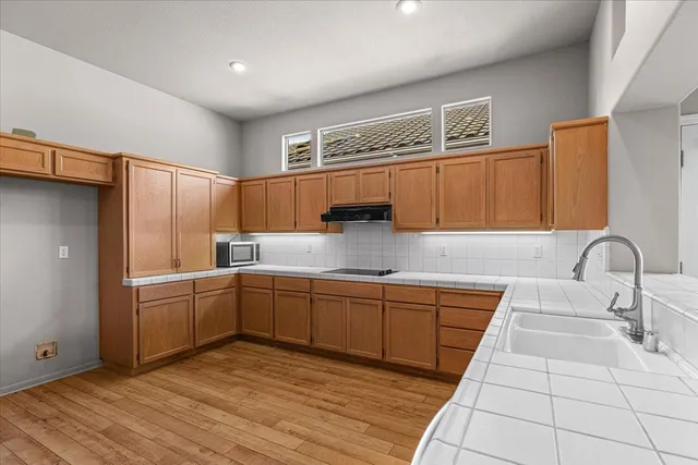 a kitchen with a refrigerator and a sink
