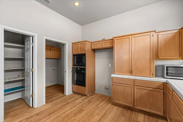 a view of a room with wooden floor fireplace and window