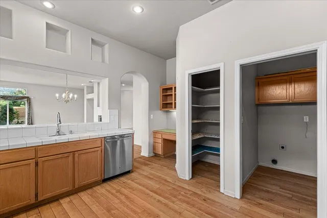 a view of empty room with wooden floor and fireplace