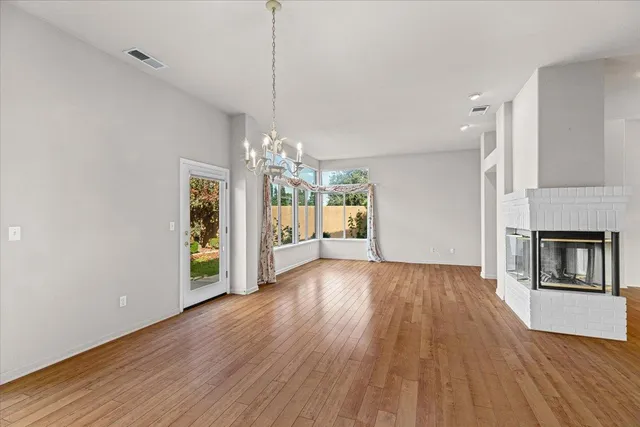 a view of a room with wooden floor and a sink