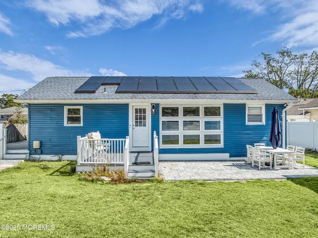 a front view of a house with a yard table and chairs
