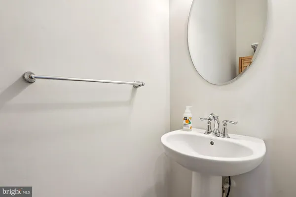 a bathroom with a sink a mirror and a toilet