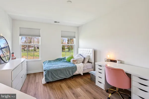 a bedroom with a bed and a chair