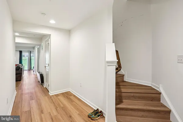 a view of a hallway with wooden floor and entryway