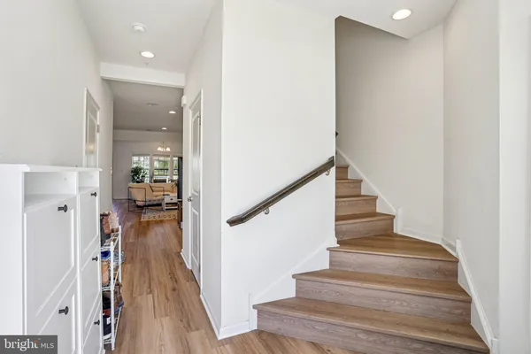a view of entryway and hall with wooden floor