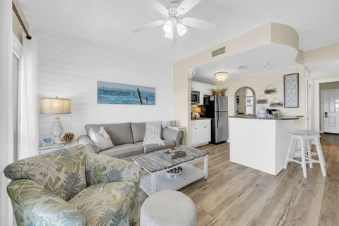 a living room with furniture and kitchen view