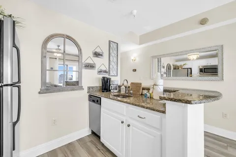 a bathroom with a granite countertop sink a mirror and a