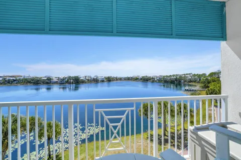 a kitchen with stainless steel appliances kitchen island granite countertop a refrigerator a stove top oven a sink dishwasher and white cabinets with wooden floor