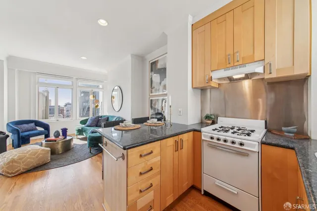 a kitchen with stainless steel appliances granite countertop a stove a sink and a refrigerator