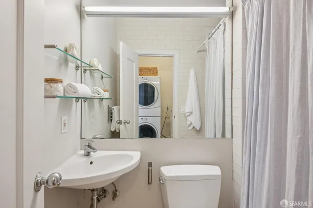 a bathroom with a sink a mirror and a toilet