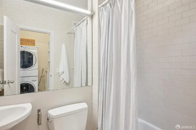 a bathroom with a toilet a sink and a bath tub