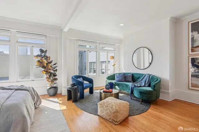 a living room with furniture fireplace and a large window