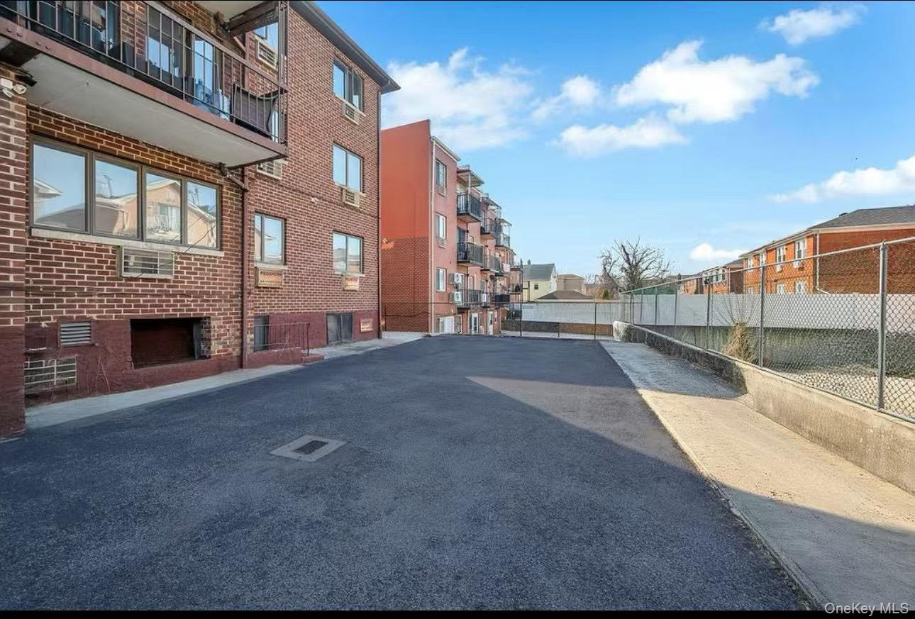 46-12 161 Street, Unit 1D Queens, NY 11358 - Photo 2 of 7 a view of a street with a building