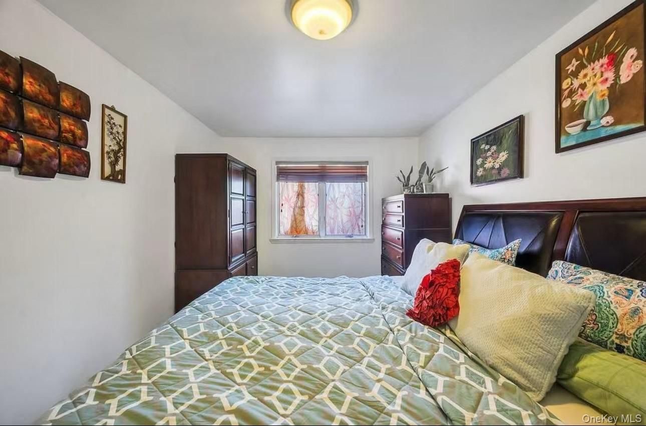 46-12 161 Street, Unit 1D Queens, NY 11358 - Photo 6 of 7 a bedroom with a bed and a window