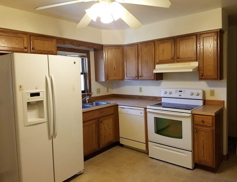 10 A Weldon Avenue Worcester, MA 01607 - Photo 1 of 10 a kitchen with stainless steel appliances a stove a refrigerator and cabinets