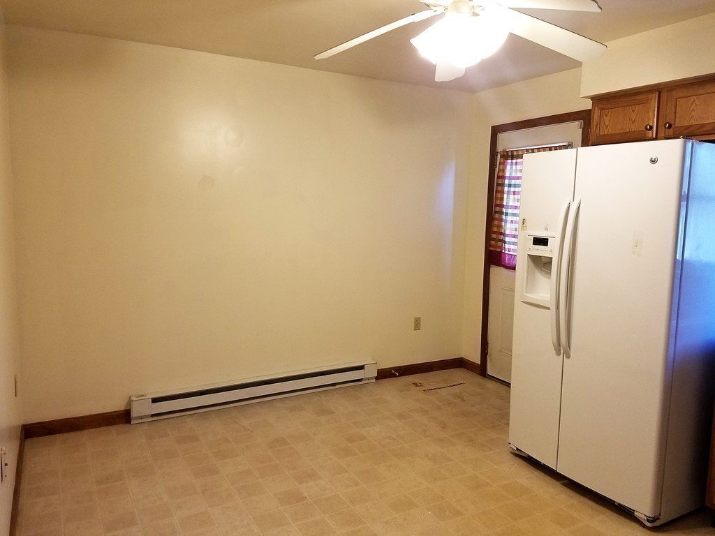 10 A Weldon Avenue Worcester, MA 01607 - Photo 5 of 10 a view of a refrigerator in kitchen and white walls