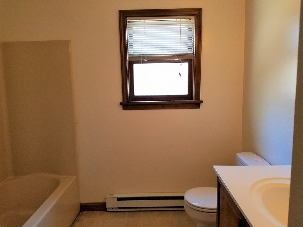 10 A Weldon Avenue Worcester, MA 01607 - Photo 9 of 10 a bathroom with a sink a toilet and a bathtub