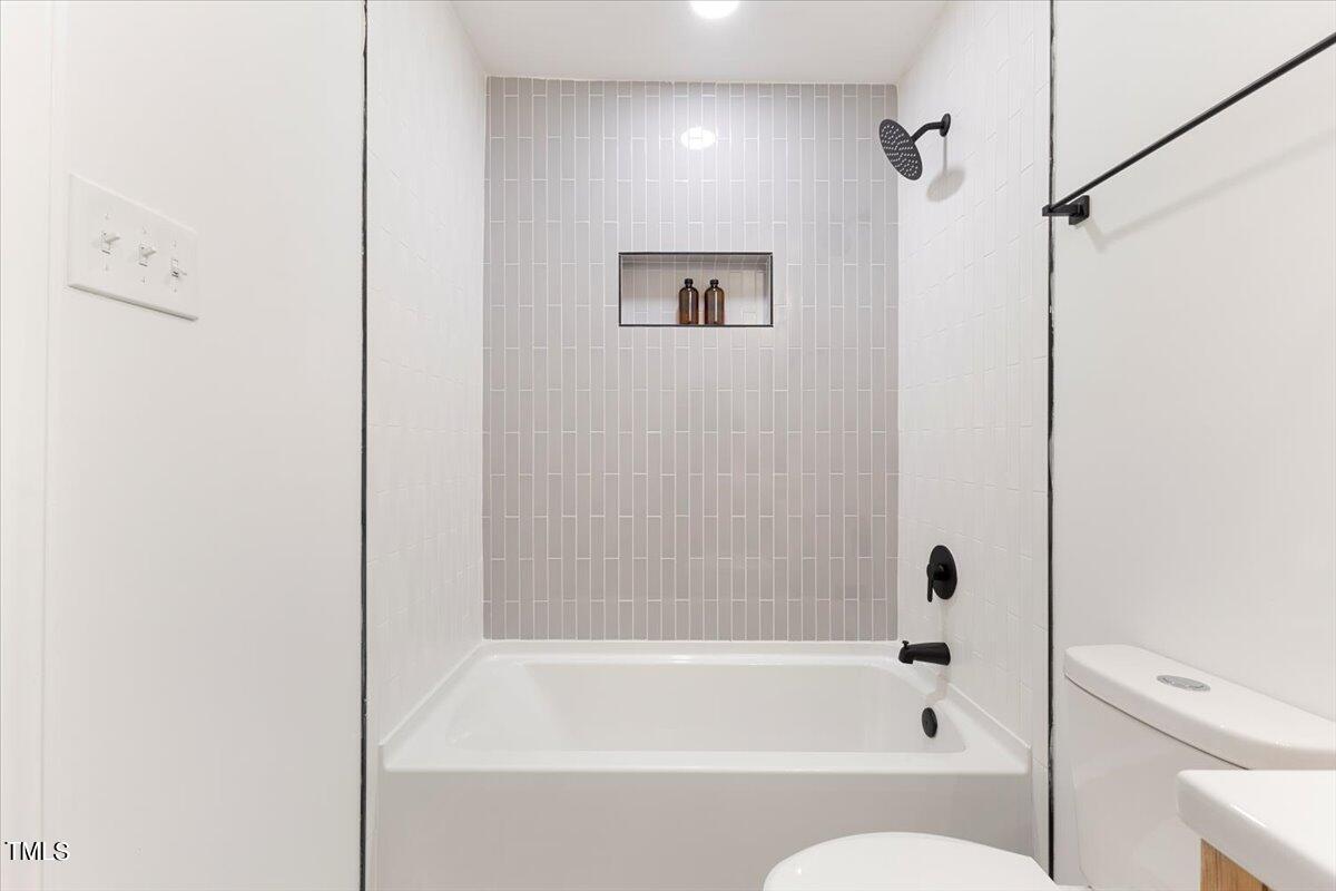 134 Radcliff Circle Durham, NC 27713 - Photo 15 of 37 a bathroom with a bathtub and a shower