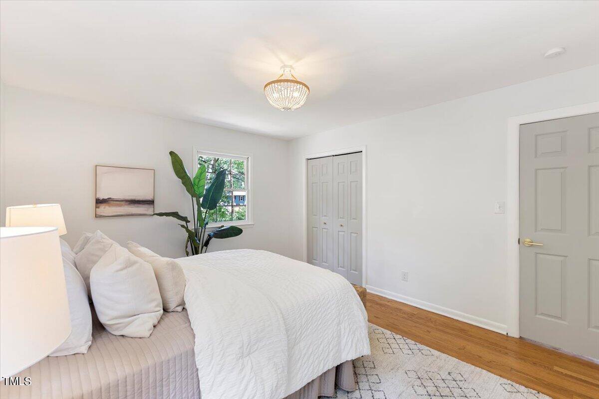 134 Radcliff Circle Durham, NC 27713 - Photo 17 of 37 a bedroom with a bed and wooden floor