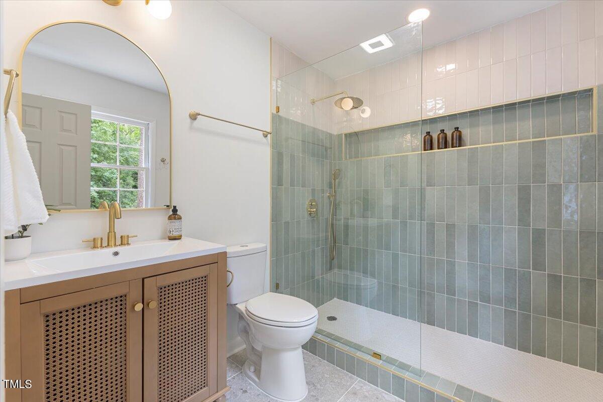 134 Radcliff Circle Durham, NC 27713 - Photo 19 of 37 a bathroom with a double vanity sink toilet and shower