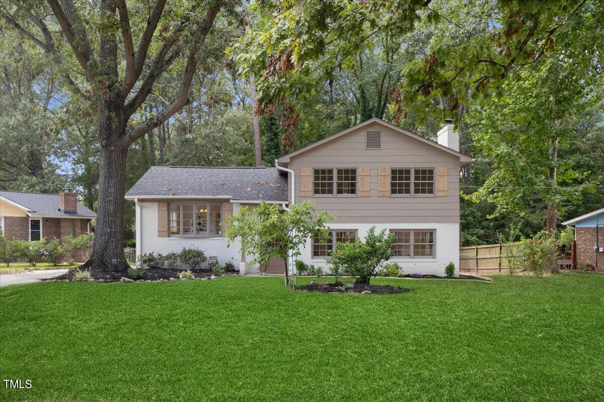 134 Radcliff Circle Durham, NC 27713 - Photo 2 of 37 a front view of a house with a garden and plants