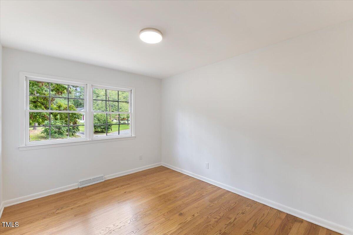 134 Radcliff Circle Durham, NC 27713 - Photo 22 of 37 an empty room with wooden floor and windows