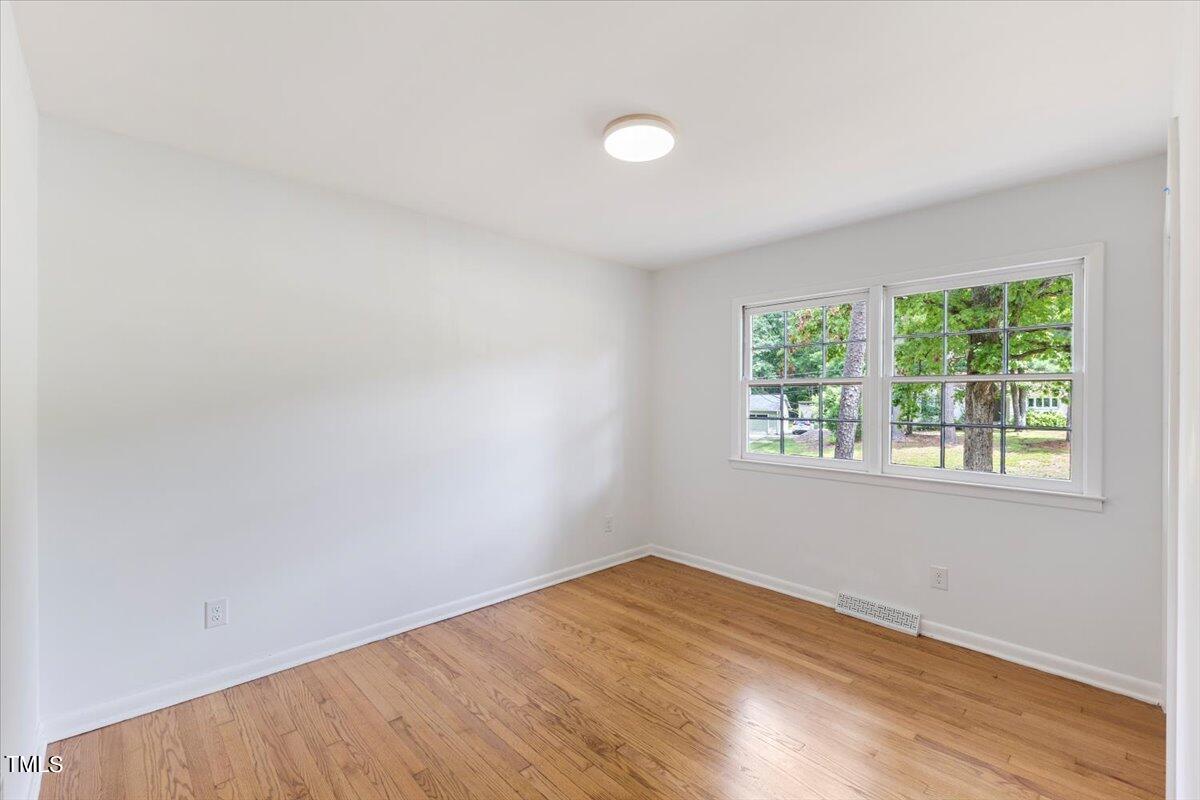 134 Radcliff Circle Durham, NC 27713 - Photo 24 of 37 an empty room with wooden floor and windows