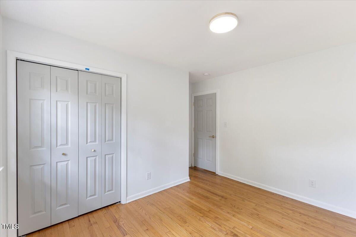 134 Radcliff Circle Durham, NC 27713 - Photo 25 of 37 a view of an empty room with wooden floor and a window