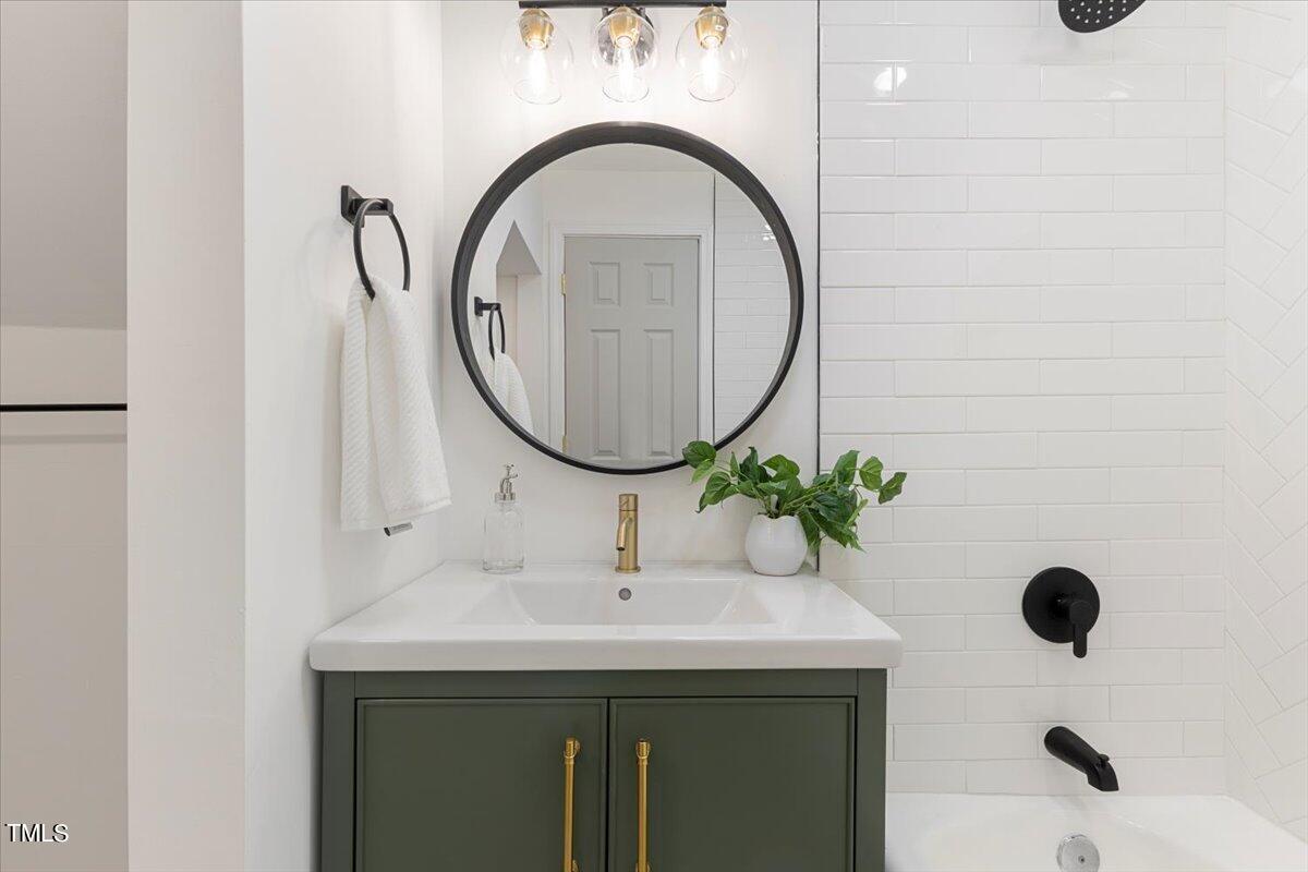 134 Radcliff Circle Durham, NC 27713 - Photo 30 of 37 a bathroom with a sink and a mirror