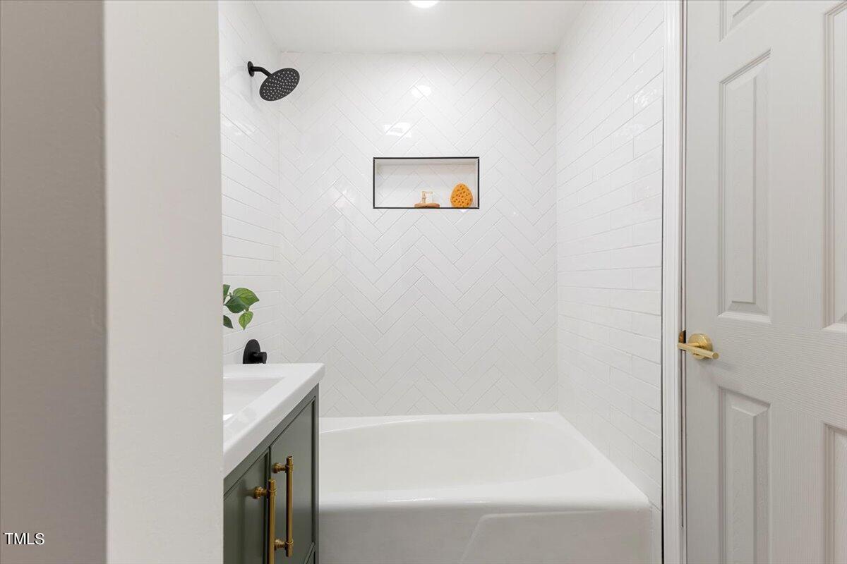 134 Radcliff Circle Durham, NC 27713 - Photo 31 of 37 a bathroom with a bathtub and shower